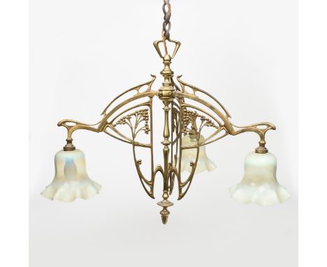 An Art Nouveau brass three light ceiling light,  cast and pierced with stylised whiplash berried sprays, the three radiating 
