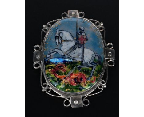 A George Hunt silver and enamel St George and the Dragon brooch, dated 1937, oval wirework frame with rivet panels, central o