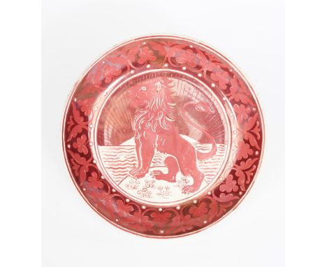 A William De Morgan Proud Lion pottery charger,  painted to the well with a proud lion, standing alert on a small island, the