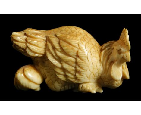 A Japanese Meiji period ivory netsuke, of a hen and chick, signed, 5cm W.