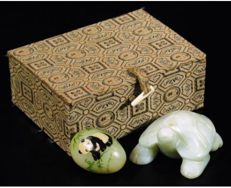 A polished jade coloured figure of a tortoise, 6cm W, and an egg handpainted with panda and bamboo shoots. (2)