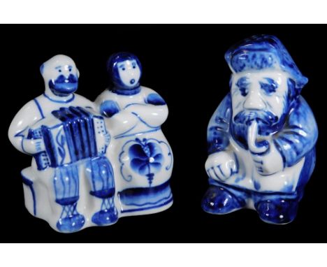 Two Russian porcelain figure groups, one with two Russian peasants, one with accordion and the other figure with her arms cro