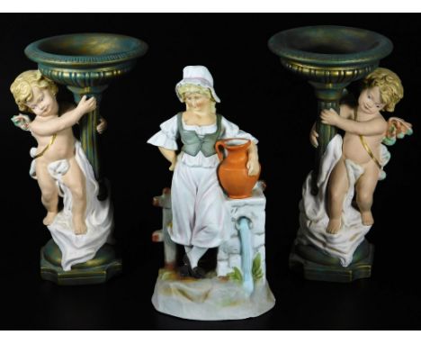 A continental bisque porcelain figure of a girl, aside ewer and bell, with a gate in the distance, on a naturalistic base, po