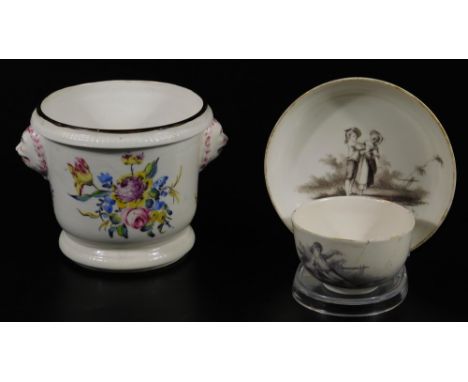 A German Berlin factory porcelain cup and saucer, c.1760, decorated with monochrome children figures in landscape, together w