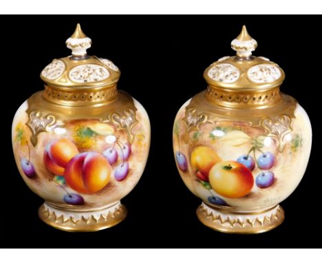 A pair of 20thC Royal Worcester porcelain fruit pattern potpourri vases and covers, each handpainted with autumnal fruits, pe