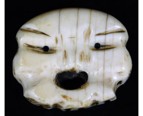 An early 20thC ivory netsuke modelled as a open mouthed face, 19thC, 5cm W.