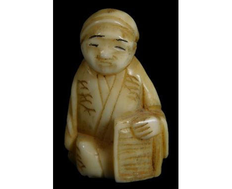 An early 20thC netsuke figure, holding a book, 3cm H.