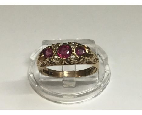 A 9ct yellow gold ruby and diamond ring, set with 3 x oval rubies and 4 x small diamonds, weighing 2.7 grams, finger size M. 