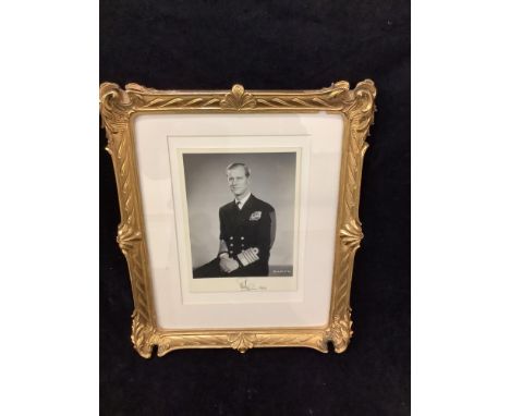 A mounted monochrome three-quarter length photograph of Her Majesty Queen Elizabeth II wearing the coronation diadem and the 