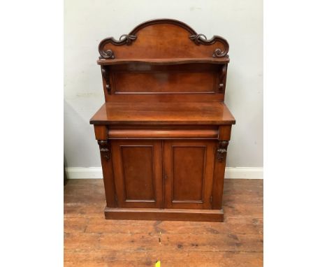 A Victorian mahogany chiffonier with small shaped shelf on back and shelved cupboard with twin doors underneath 91cm wide, 41
