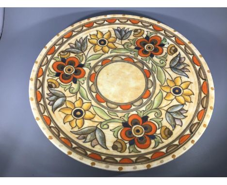 A large Crown Ducal pottery charger by Charlotte Rhead, decorated with scrolling foliage, no.6189 'Mexican' pattern, maker's 