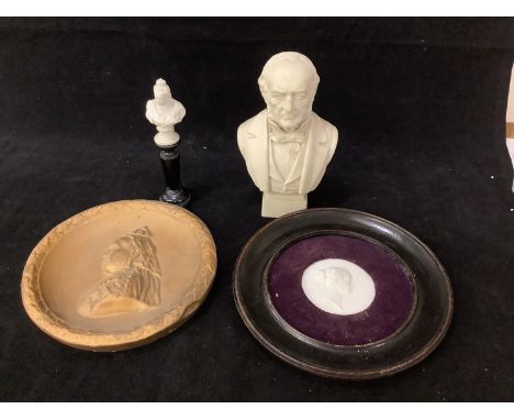 A 19th century parian porcelain bust of William Gladstone, 19cm high, together with a gold-painted relief plaque of HMQV, a m