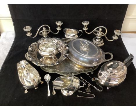 A small quantity of mixed silver-plated hollowware comprising a pair of candelabra, a pierced shaped tray, a three-piece tea 