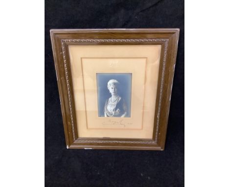 A signed half-length photograph of King George V in military uniform and matching photograph of Queen Mary, respectively sign
