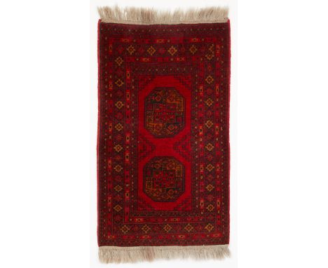 Turkish handwoven wool rug with nine incremental borders surrounding a central field with two polygonal medallions. Woven in 