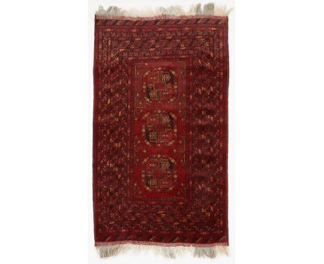 Turkish hand-woven wool rug. Red field with ten incremental borders surrounding a central field with three polygonal medallio