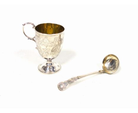 Victorian silver pedestal christening mug with all-over chased floral decoration initialled "N", with a leaf capped scroll ha