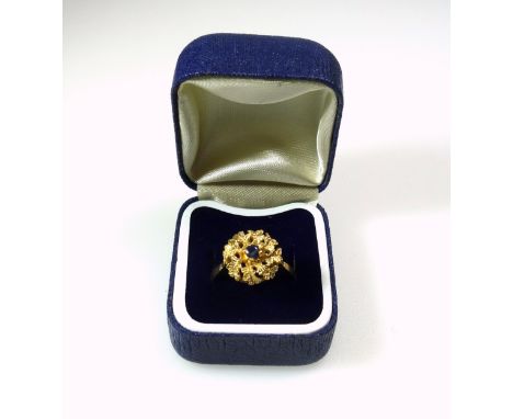 Foreign yellow metal ring with a sapphire in a floral setting, stamped 18k, 5grs, cased. (2) 