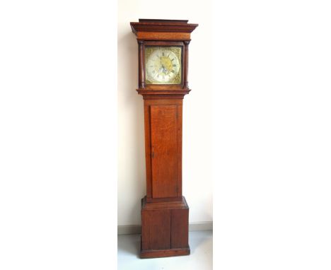 George III longcase clock with a brass dial, silvered chapter ring with Roman numerals, and a semi-circular calendar aperture