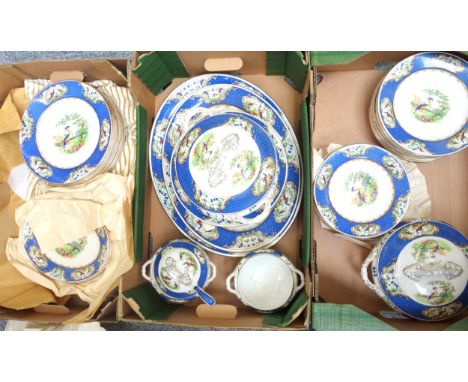 Quantity of Wilton Ware dinner service decorated with bird of paradise and blue border, including two tureens with covers, tw