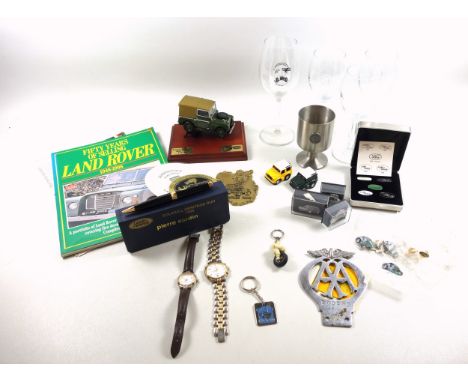 Michelin Bibendum man keyring with rotating tyre, an AA metal badge, Land Rover enamel badges, model of a Land Rover and othe