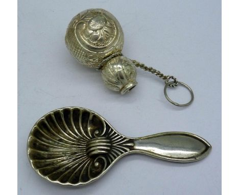 A white metal caddy spoon and silver jug, no stopper