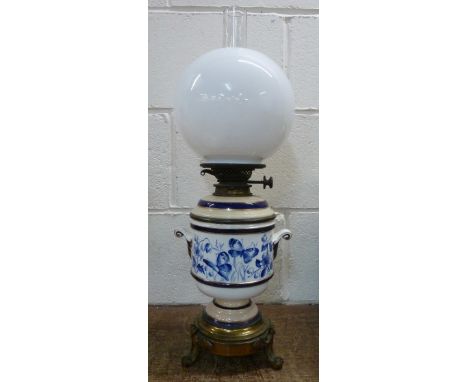 A gilt brass and blue and white china oil lamp