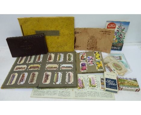 A collection of cigarette cards, silks, playing cards, cigarette card albums, etc.