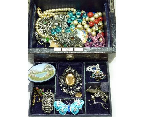 A Victorian leather covered jewellery box with vintage jewellery, including marcasite, enamel brooches, silver earrings, etc.