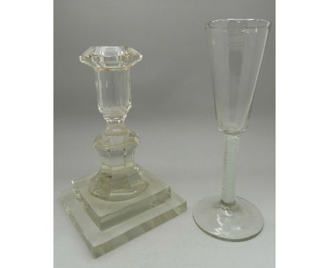 A 19th Century glass with twist stem and a heavy glass candlestick, height of glass 20.5cm