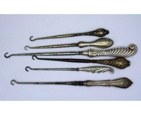 Six silver handled button hooks