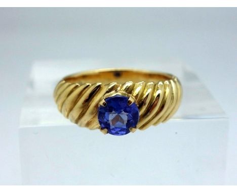 An 18ct gold and blue stone ring, weight 5.1g, size K