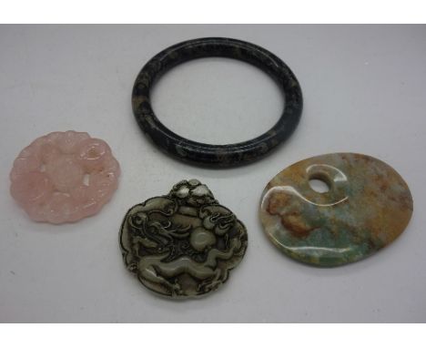 Three pendants and a bangle including rose quartz and jade