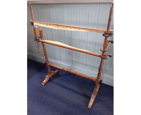 A VICTORIAN STAINED BEECH TAPESTRY FRAME turned supports on shaped feet with ebonised tightening nuts 85cm wide. Provenance: 