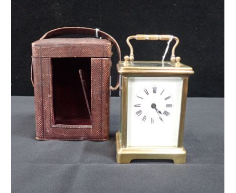 A BRASS CARRIAGE CLOCK BY R &amp; C, PARIS with leather case (working, leather case a/f)