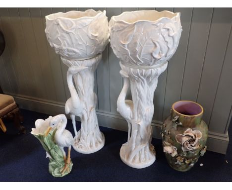 A PAIR OF WHITE CERAMIC JARDINIERES ON STANDS moulded as a crane (non-opposing) 1101cm high, a similar vase, and a pottery va