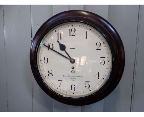 A SMITHS OFFICE DIAL CLOCK marked with the government broad arrow, 1950, in stained wooden frame