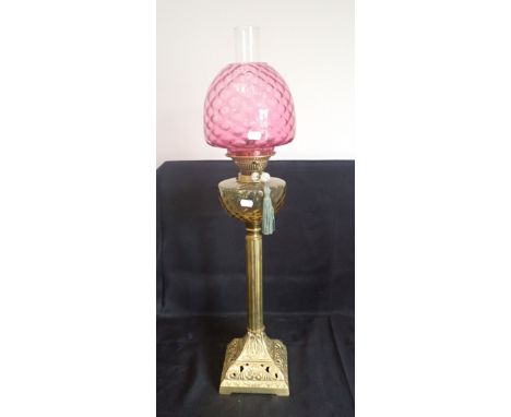 A 19TH CENTURY BRASS TABLE OIL LAMP with Messenger No 2 burner, dimpled orange glass reservoir on fluted column and square fo