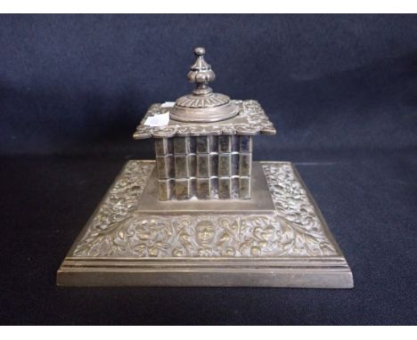 A VICTORIAN BRASS INKWELL BY WILLIAM TONKS &amp; SONS the hinged lid opening to a porcelain bowl, on a stepped plinth base, 1