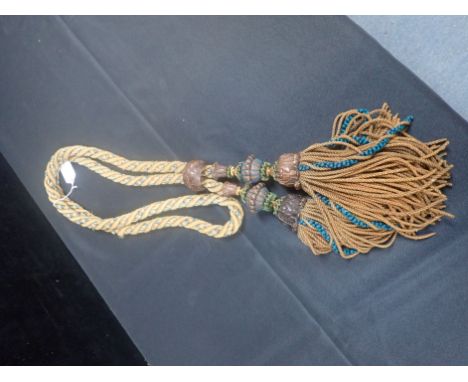 A CARVED OAK DECORATED TIE-BACK