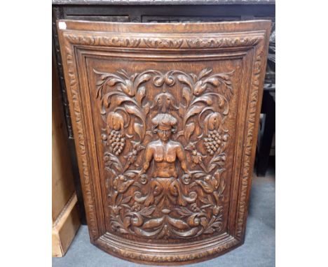 A 19TH CENTURY CARVED OAK BOWFRONT FIRESCREEN (made from a door; patched lock and hinge holes) 67 x 49cm