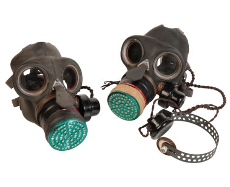 TWO BRITISH MILITARY GAS MASKS with communication ear sets, dated 1933 made by W &amp; G Ltd (2)