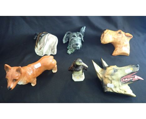 THREE ROYAL CROWN DEVON CERAMIC DOG PORTRAITS the largest, the Alsatian, 18cm wide, together with a Royal Dux penguin and a c