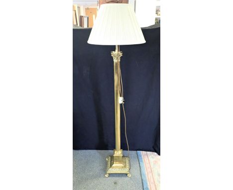 A BRASS STANDARD LAMP with composite capital on a reeded columnar stem, to moulded pedestal base, 160cm high to top of the sh