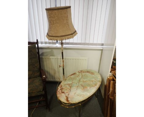 A KITSCH ONYX TOPPED OVAL COFFEE TABLE with brass base cast with swags 98 x 56cm, and a similar standard lamp (2)