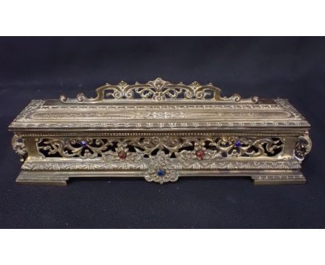 A VICTORIAN GILT BRASS DESK STAND pierced and 'jewelled', containing two ceramic inkwells 27cm wide