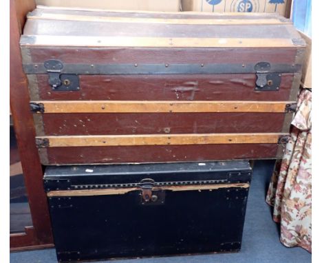 A CANVAS AND WOOD-BOUND DOMED TOP TRAVELLING TRUNK 93cm wide, and one other trunk76cm wide (2). Provenance: The Estate of the