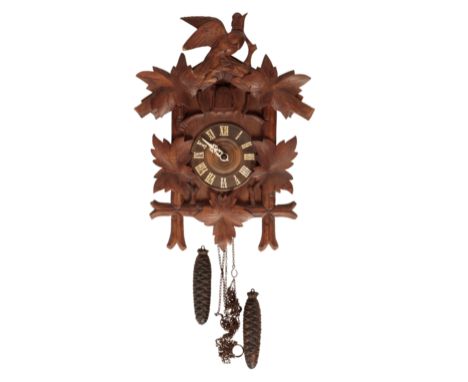 A BLACK FOREST CUCKOO CLOCK of typical form, the wooden chapter ring with attached Roman numerals, pinecone weight-driven mov