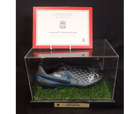 A FOOTBALL BOOT SIGNED BY VIRGIL VAN DIJK in a perspex case, 20.5cm high x 31cm wide, with Liverpool FC certificate of authen