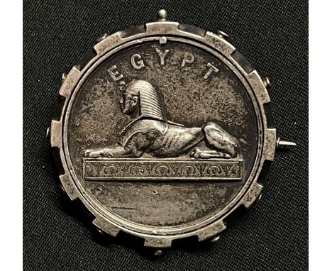 Victorian Egypt Campaign Medal which has been mounted into a circular cog wheel design frame and brooch pinned. Medal can be 